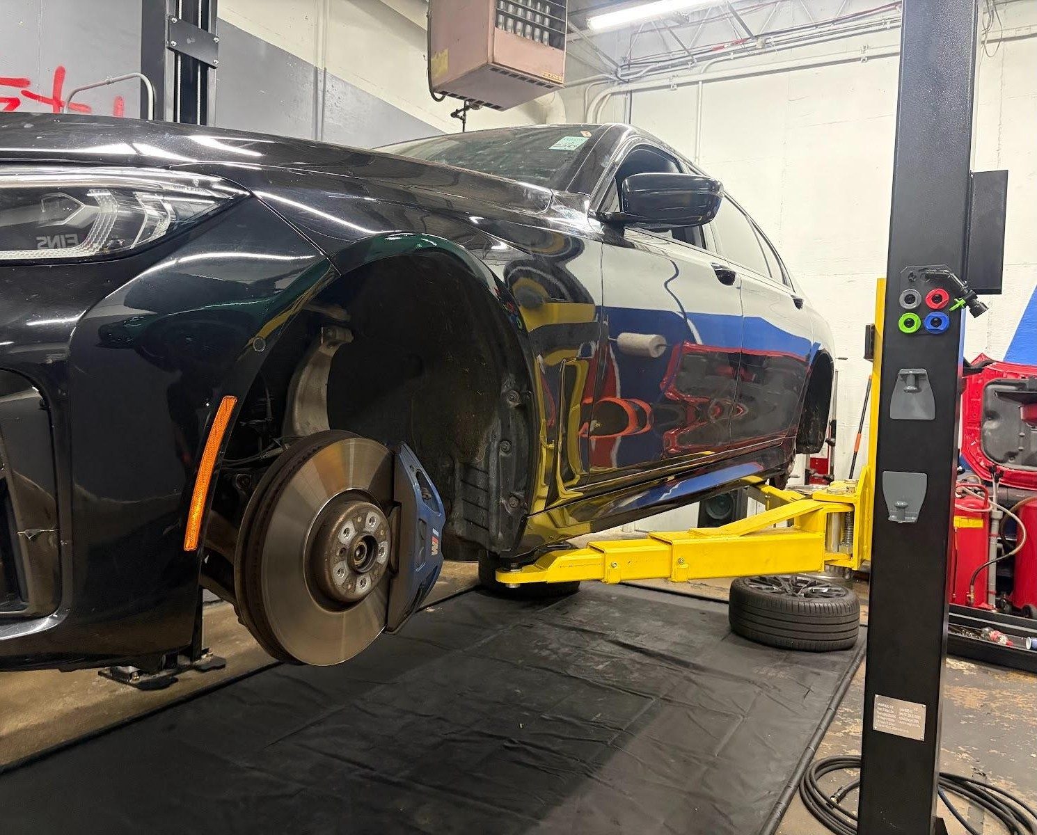Fresh rotor and painted caliper on the lift