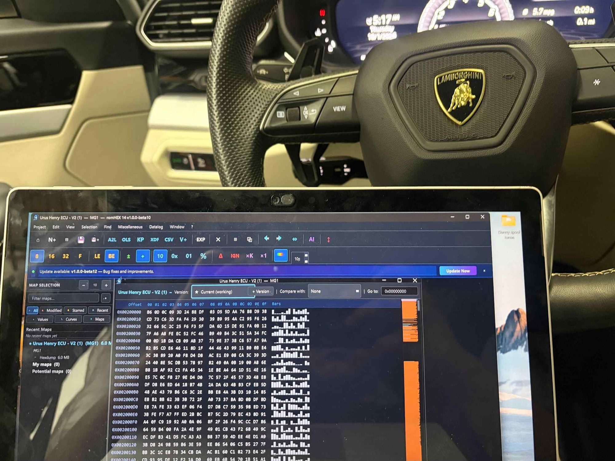 Lamborghini steering wheel and a laptop mid-flash