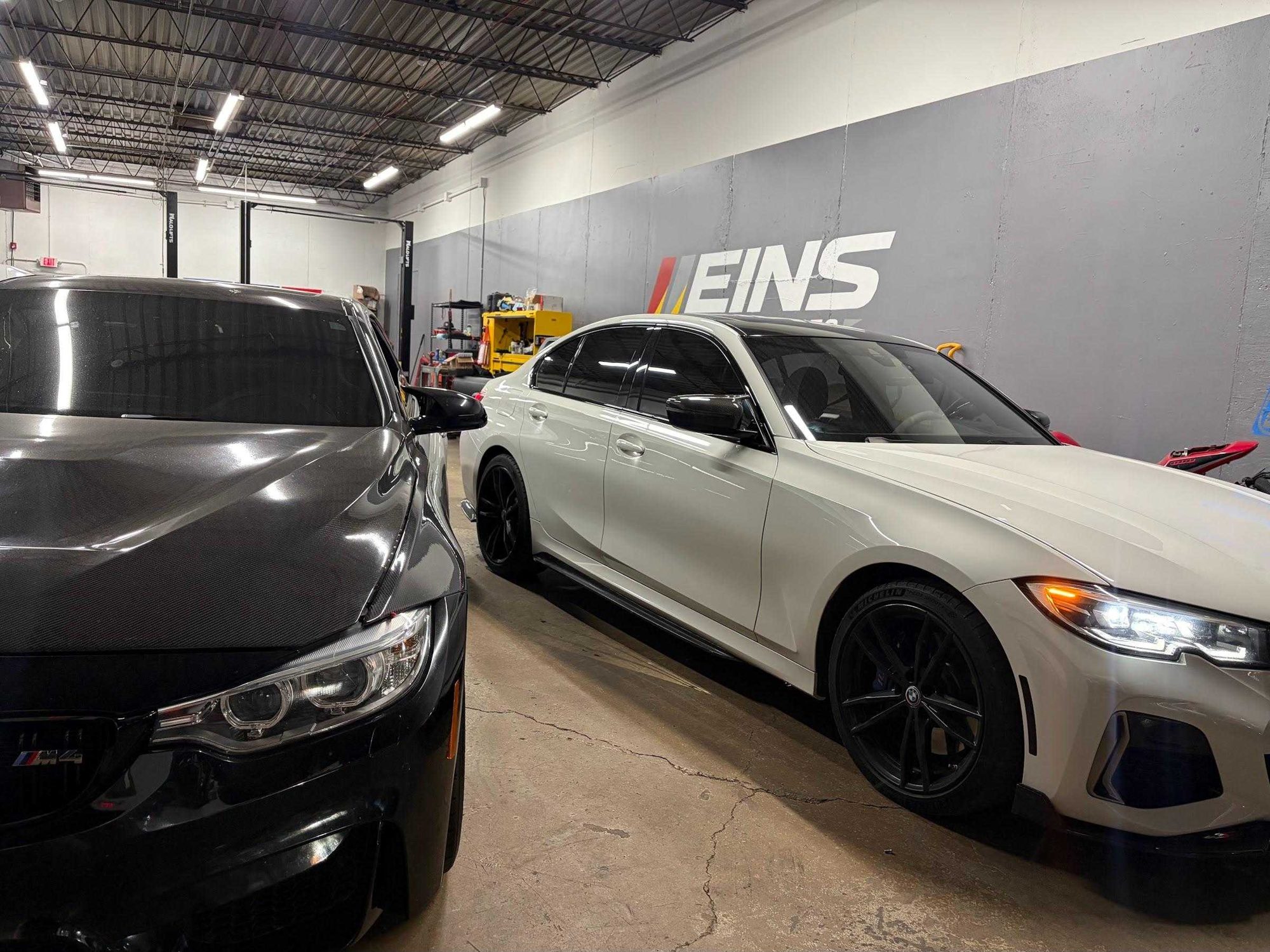 Black BMW in front of the Eins Motorsports wall